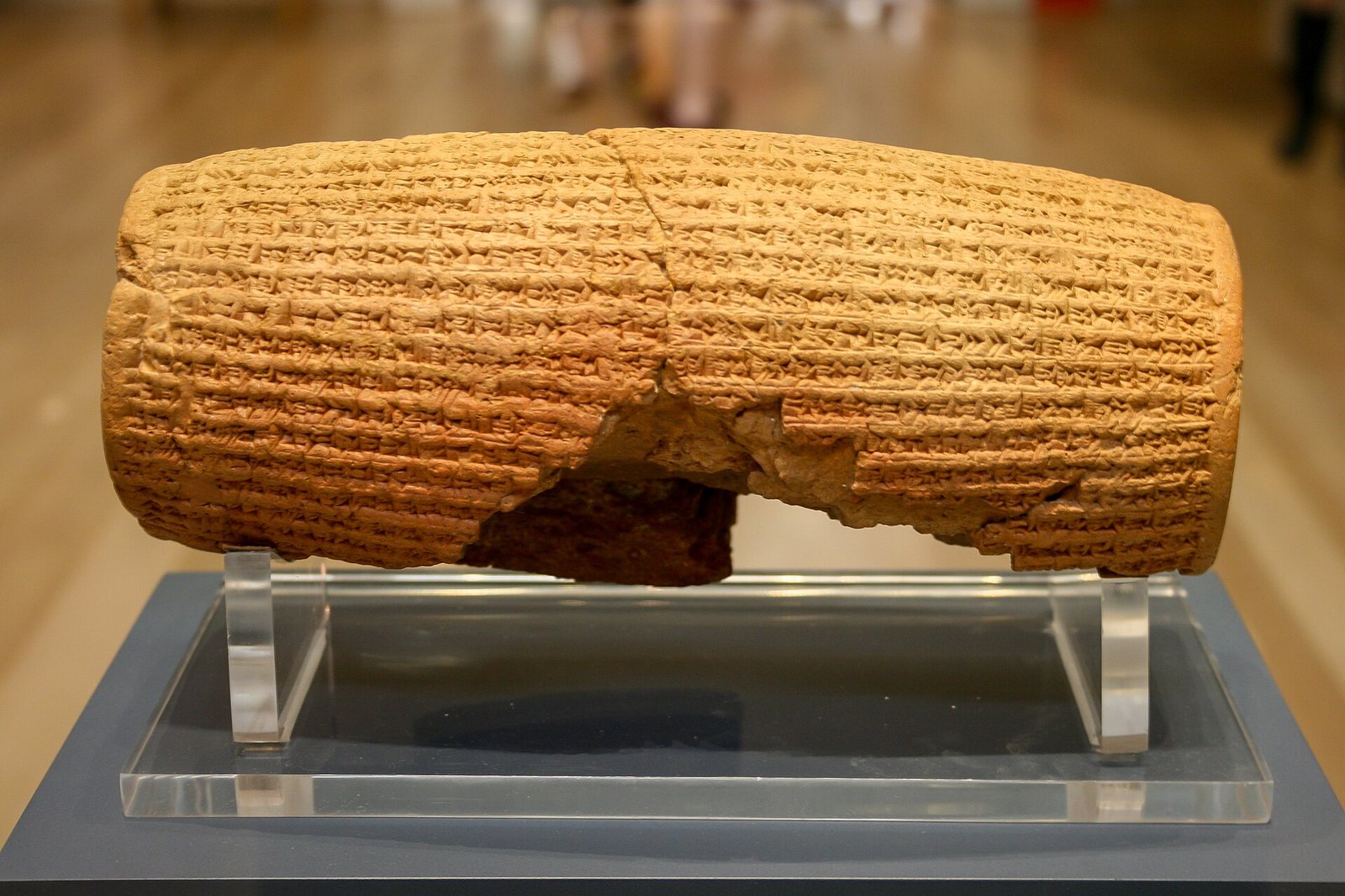 The Cyrus Cylinder, a barrel-shaped clay object covered in cuneiform.
