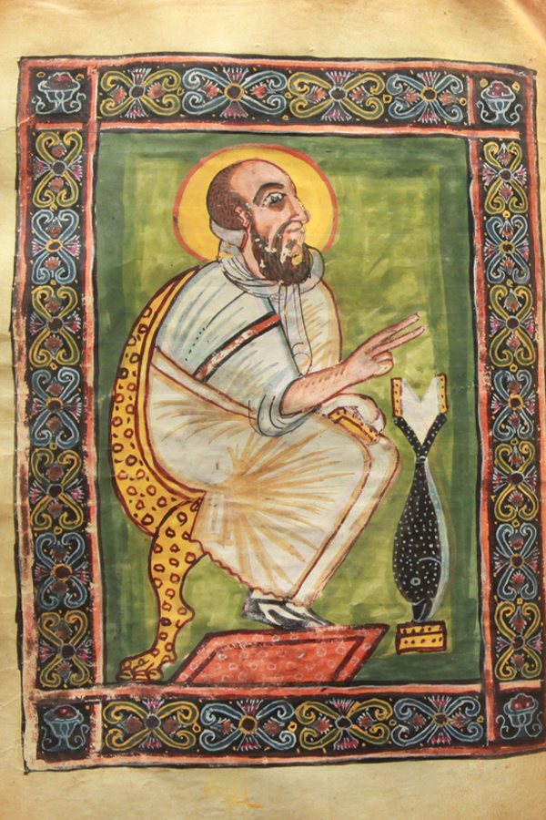 An illuminated page from the Garima Gospels showing an evangelist portrait in bright colours.
