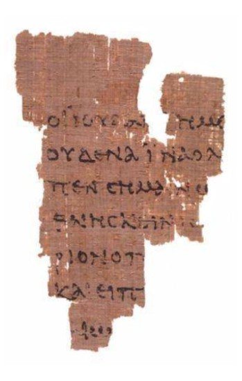 A small ragged papyrus fragment with a few lines of Greek — Papyrus 52, the oldest known Gospel fragment.