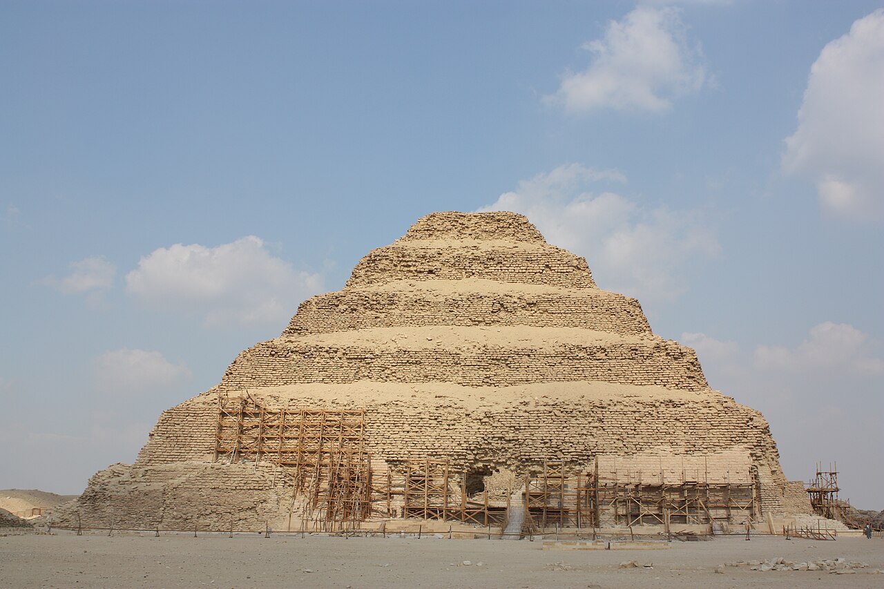 The stepped tiers of the Pyramid of Djoser at Saqqara, with modern scaffolding along the lower courses.