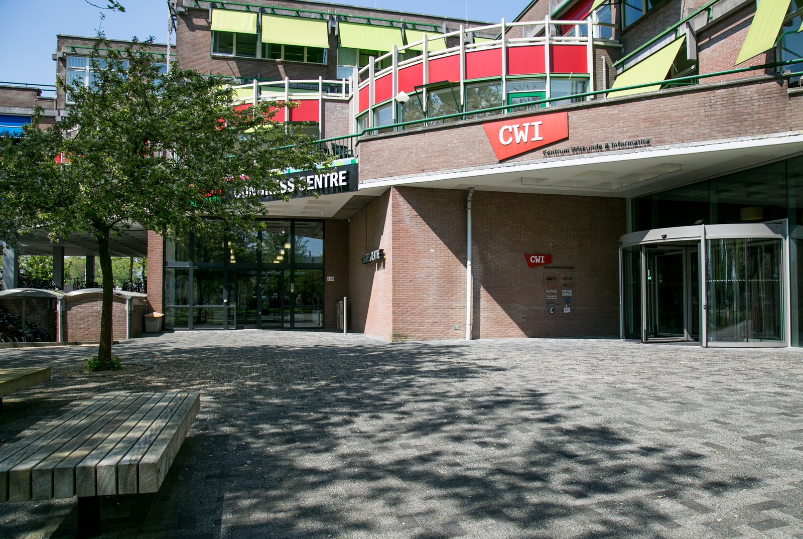 The brick entrance of the CWI research institute in Amsterdam with a red CWI sign